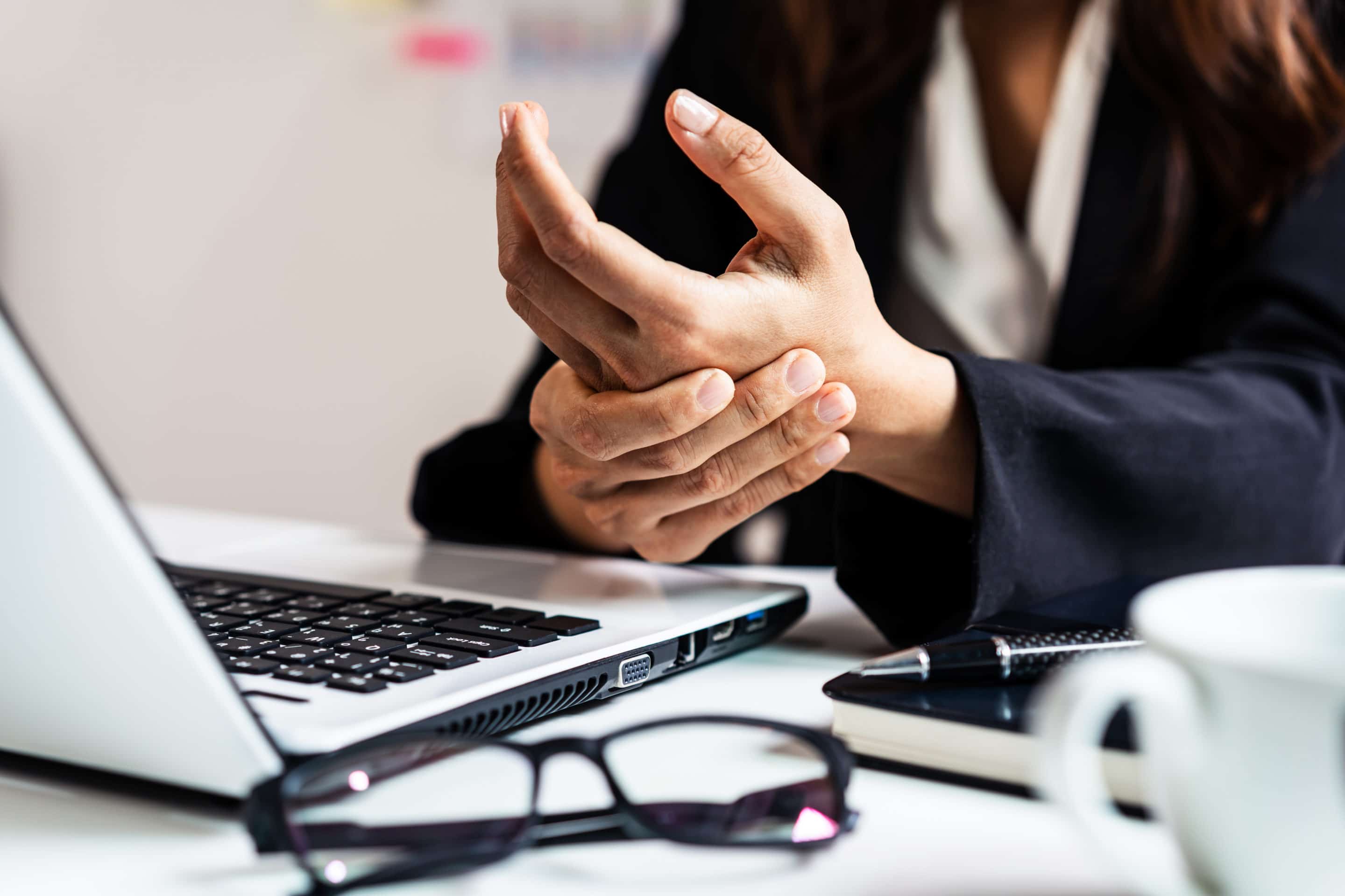 Stressed business woman suffering from wrist pain, Office syndrome concept